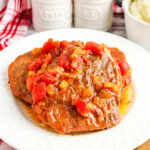 Swiss Steak served on a white plate.