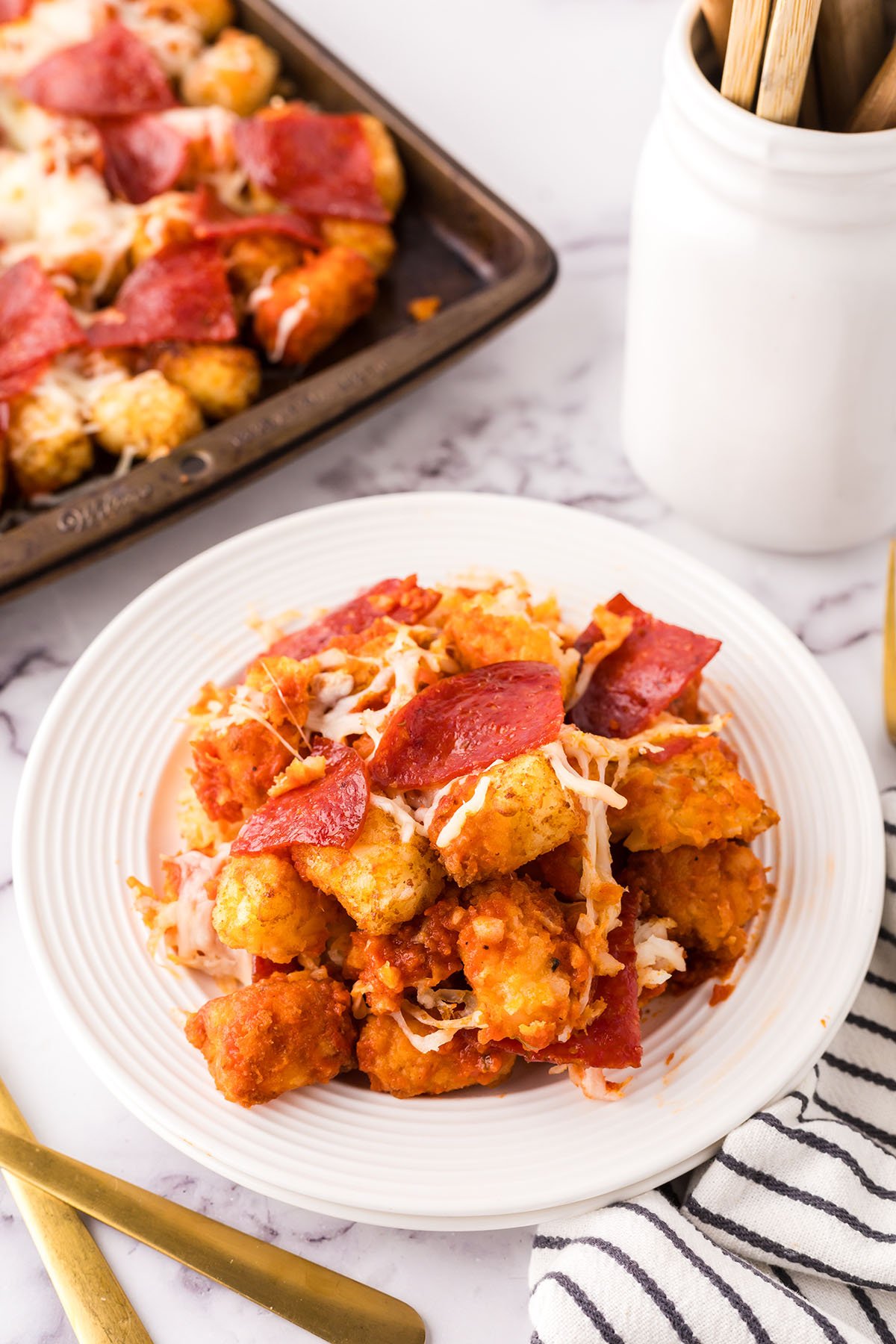 A serving of Pepperoni Pizza Totchos on a white plate.
