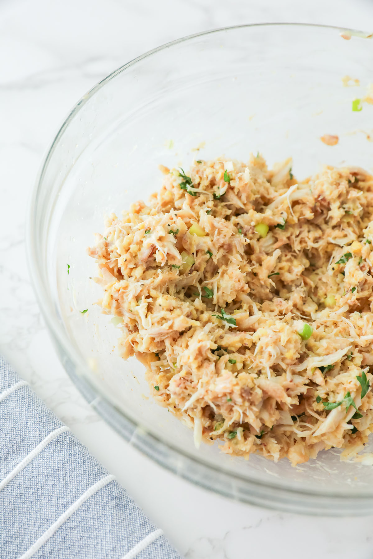 Crab cake mixture combined in a mixing bowl.