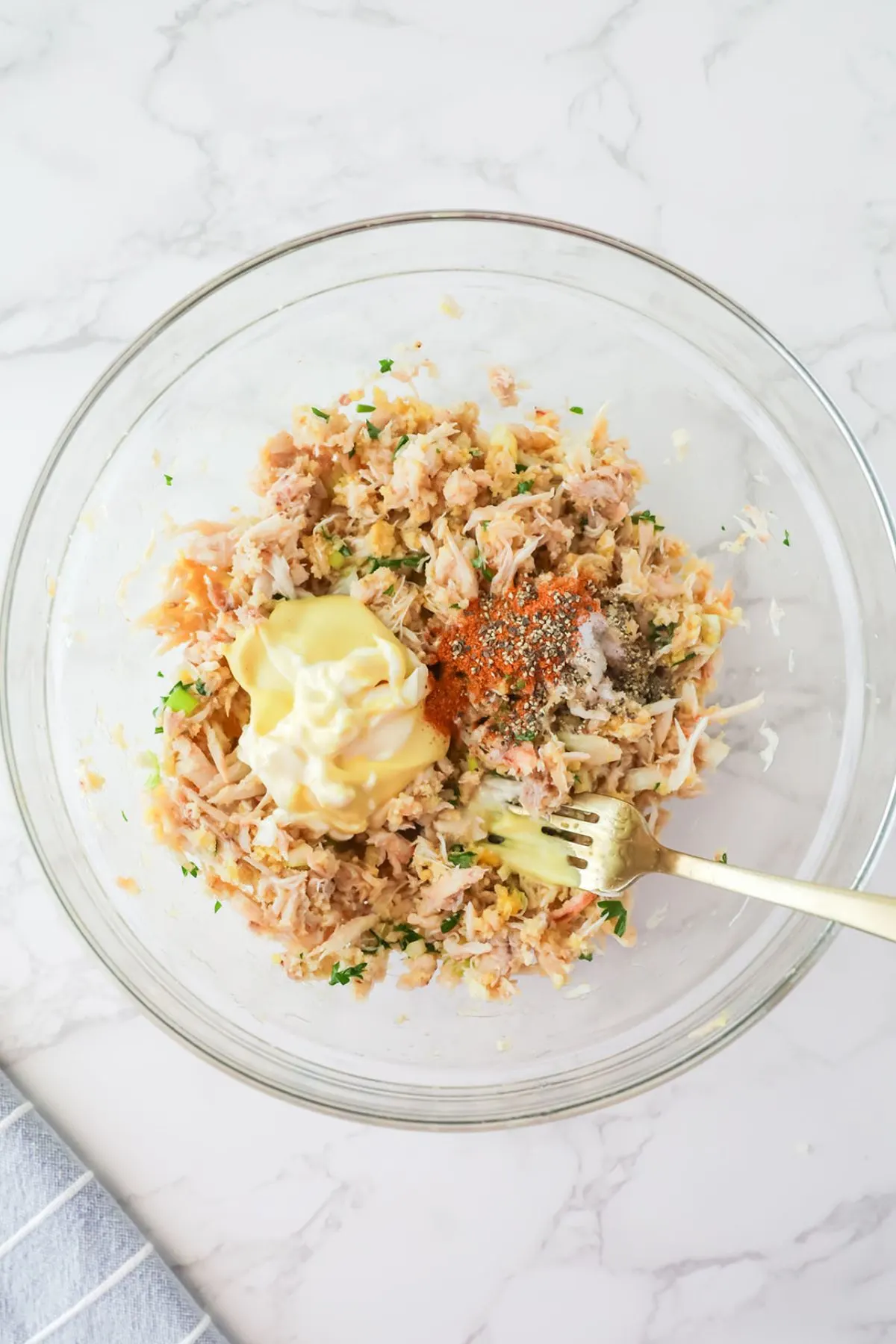 Mayonnaise, Dijon mustard, Old Bay seasoning, salt and pepper added to crab mixture in the mixing bowl.