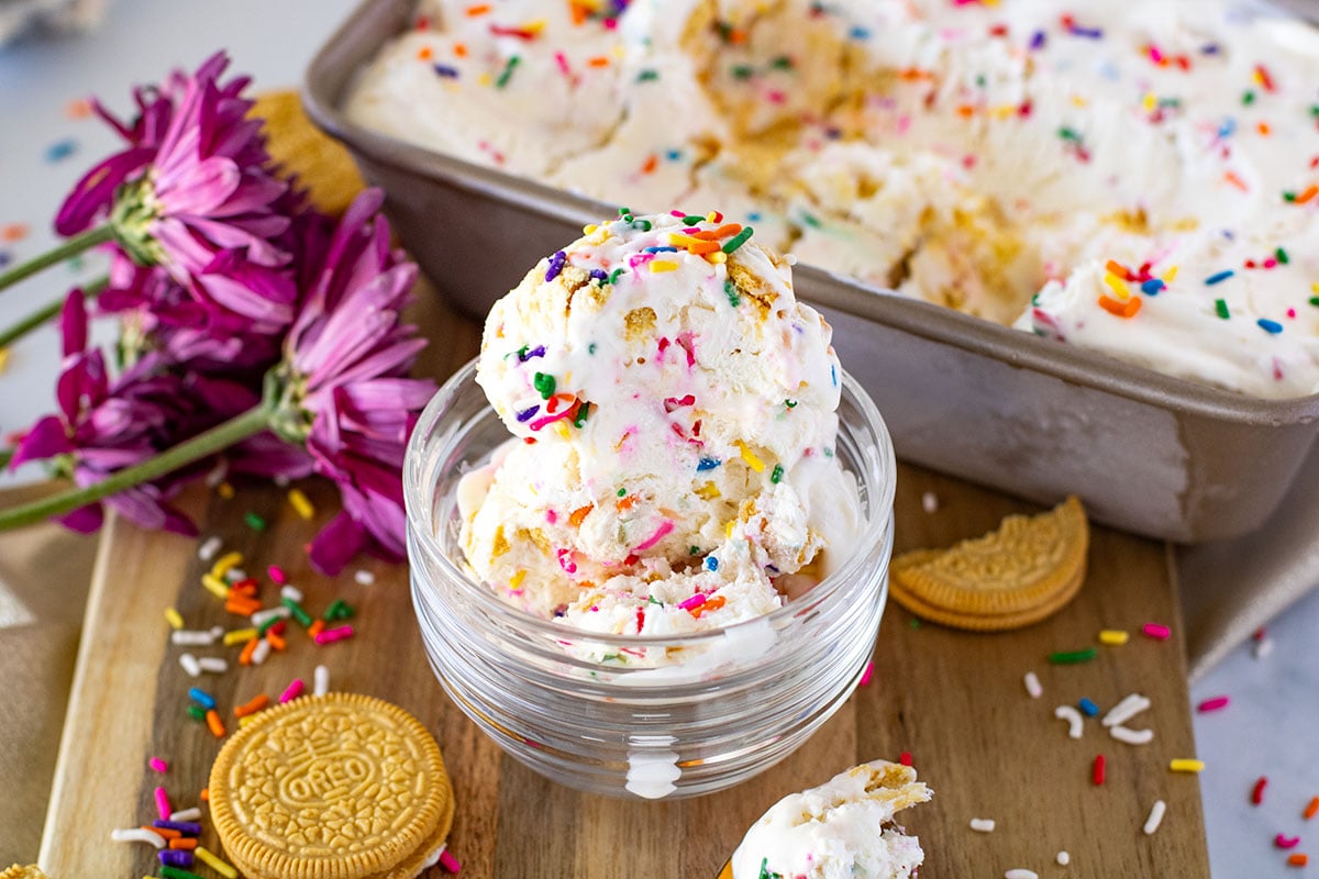 Golden Oreo vanilla ice cream in glass dessert bowl with sprinkles on top.