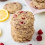 Lemon Raspberry Cookies stacked on top of each other on a countertop.