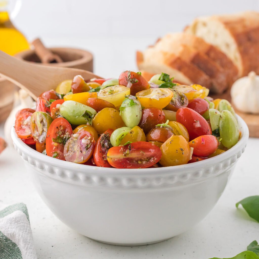 Marinated Cherry Tomatoes in a white serving bowl.