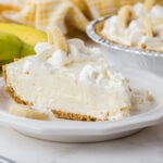 A slice of Banana Cream Pie on a white plate.