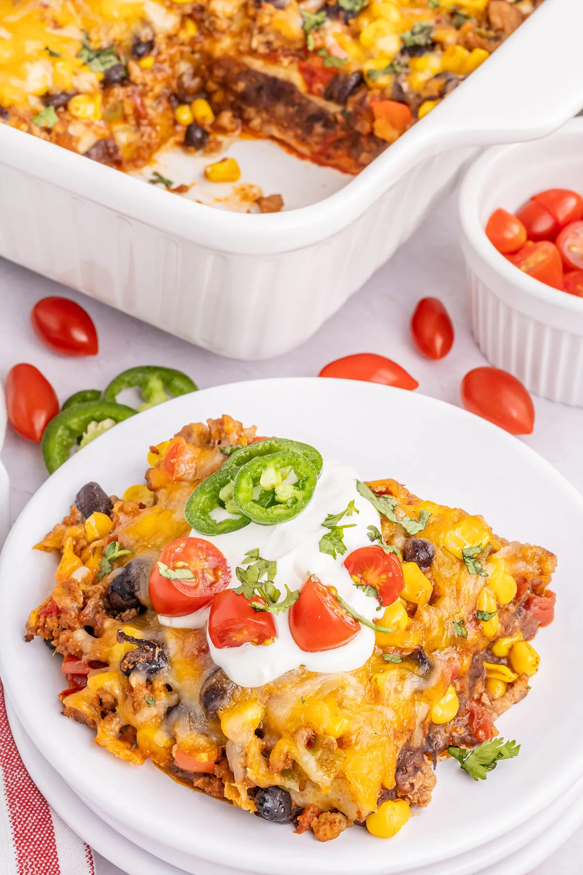 Taco Lasagna served on a white plate.
