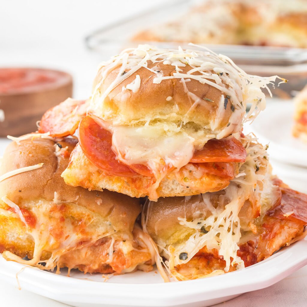 Three Pepperoni Pizza Sliders on a white plate.