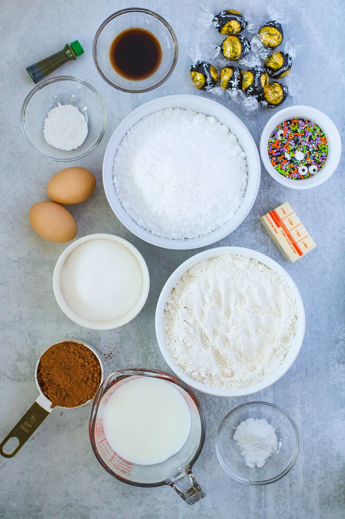 Ingredients to make spider donuts set out on the counter top.