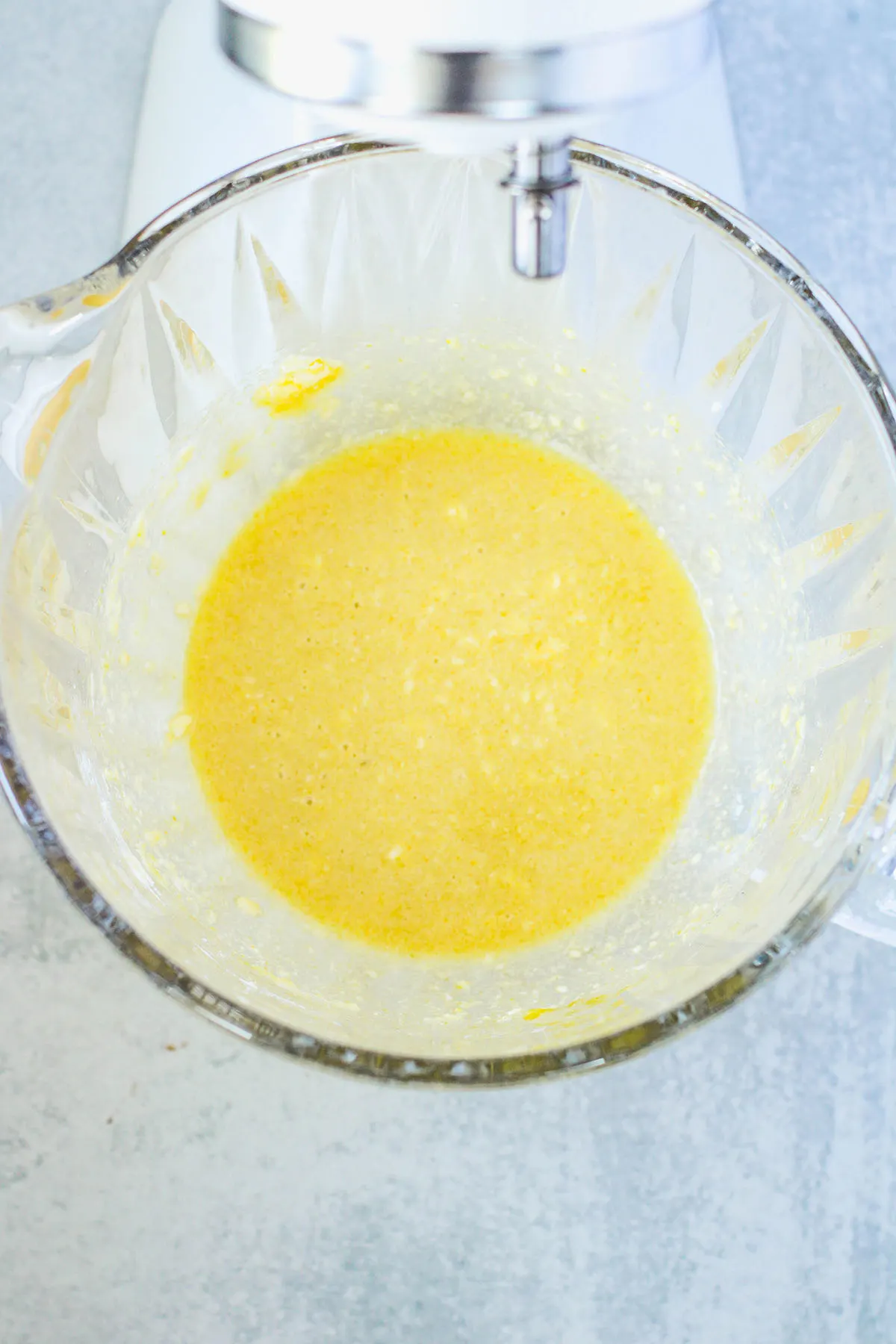 Butter, sugar, vanilla, and eggs in a mixing bowl.