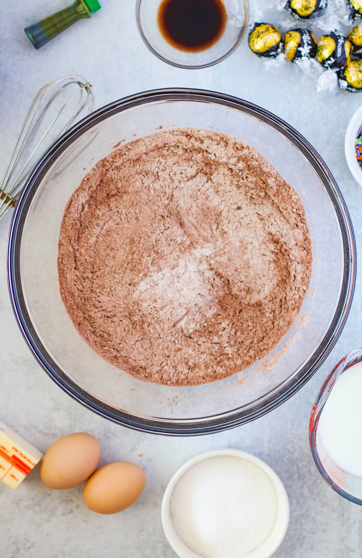 Flour, baking powder, baking soda, and cocoa powder in a mixing bowl.
