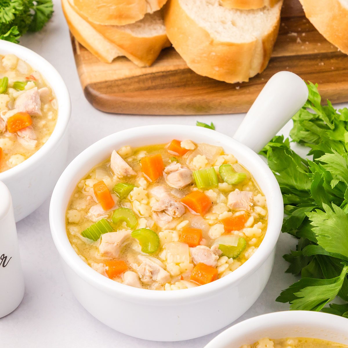 Chicken and Stars Soup served in a white bowl.