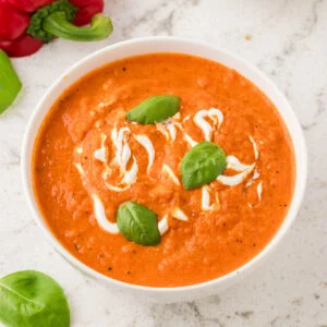 Roasted Red Pepper Soup served in a white bowl.