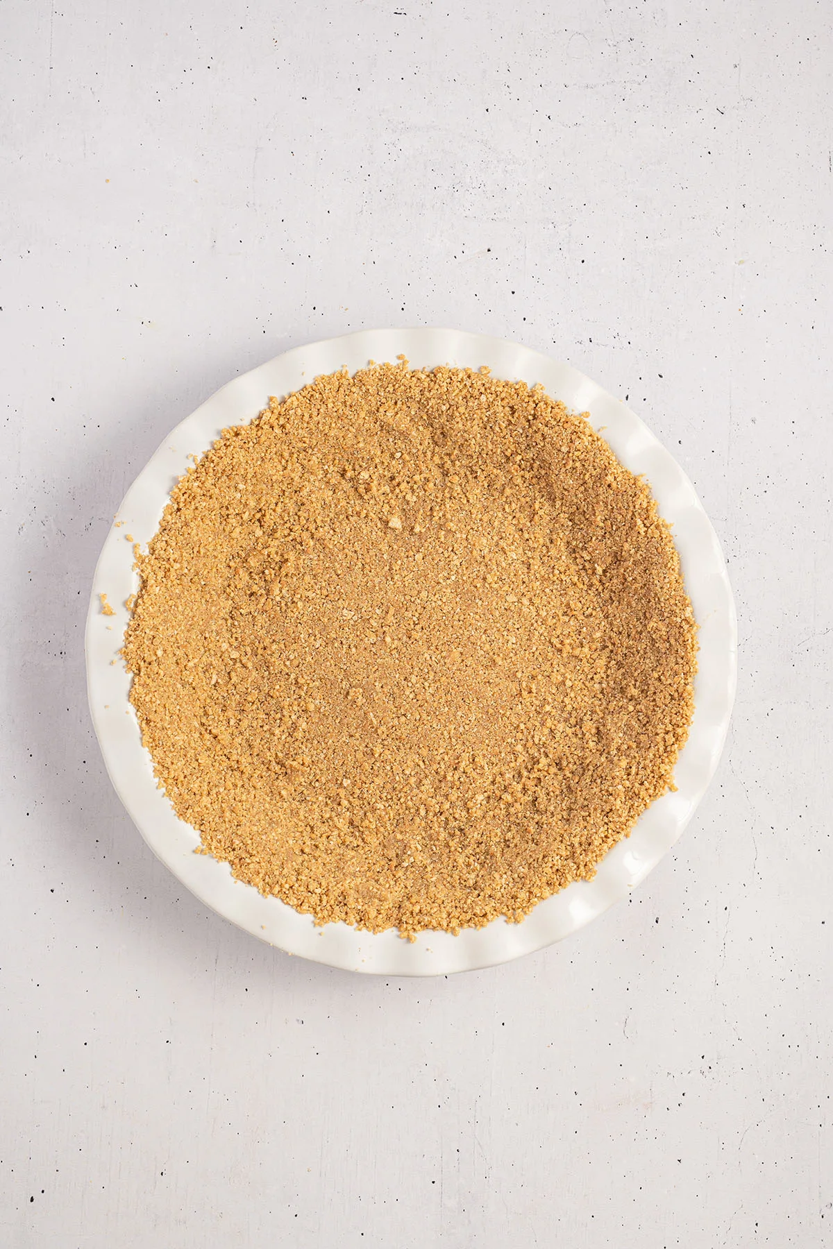 Graham cracker crumb crust pressed into the bottom of a pie dish.
