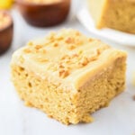 Banana Blondie topped with frosting and chopped nuts.