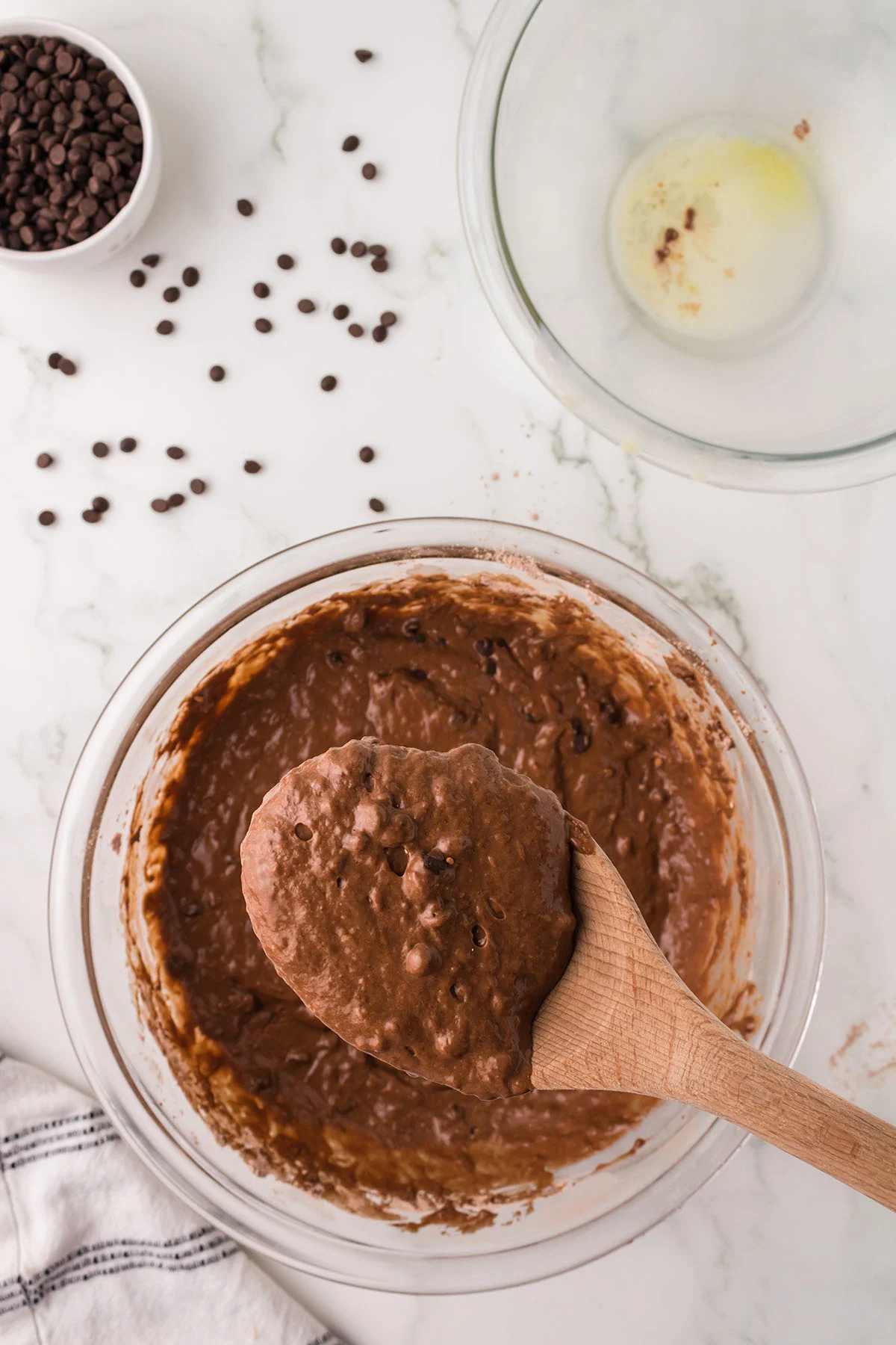 Chocolate waffle batter in a glass mixing bowl.