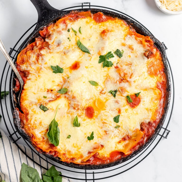 Skillet Lasagna in a cast iron skillet on a wire rack.