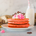 Pink Pancakes on a white plate.
