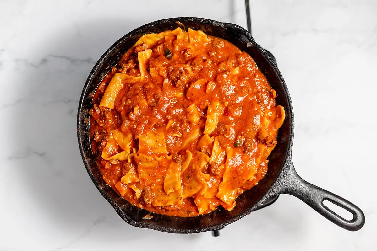 Broken lasagna noodles simmered in the cast iron skillet with the ground beef and marinara mixture.