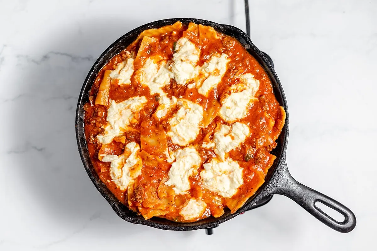 The ricotta mixture was added to the lasagna in a cast iron skillet.