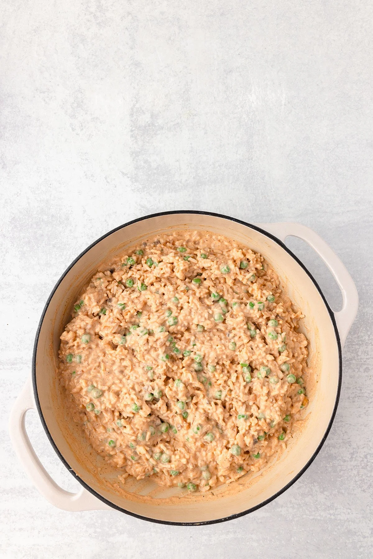 The rice mixture and peas mixture in the skillet.