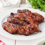 BBQ Boneless Pork Ribs on a white plate.
