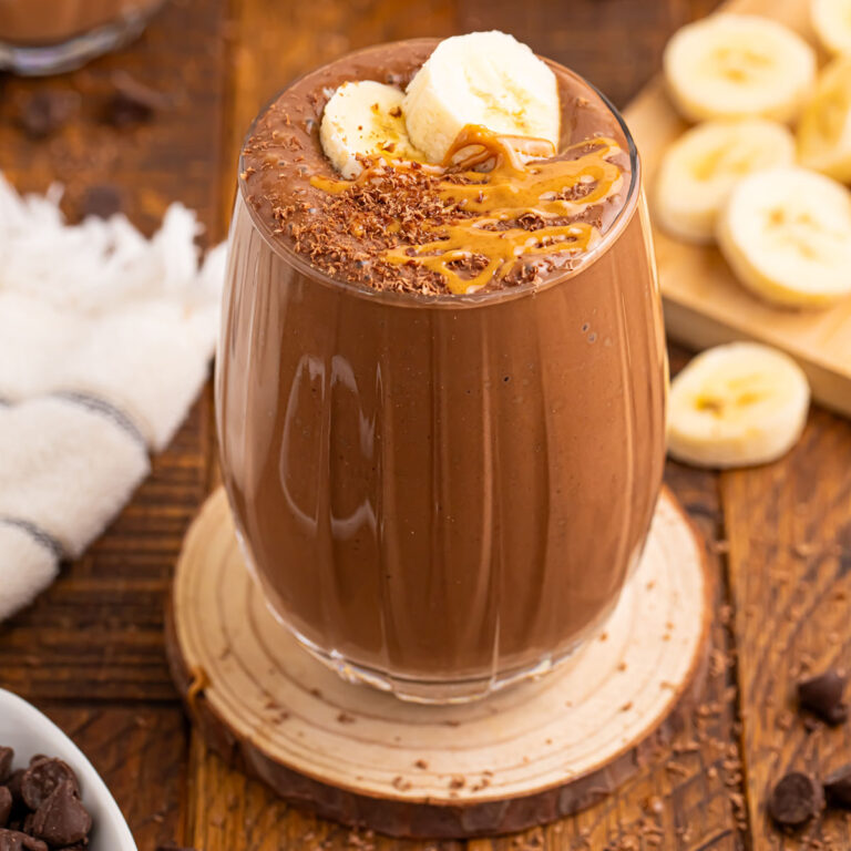 Chocolate Peanut Butter Smoothie served in a glass, topped with sliced bananas.