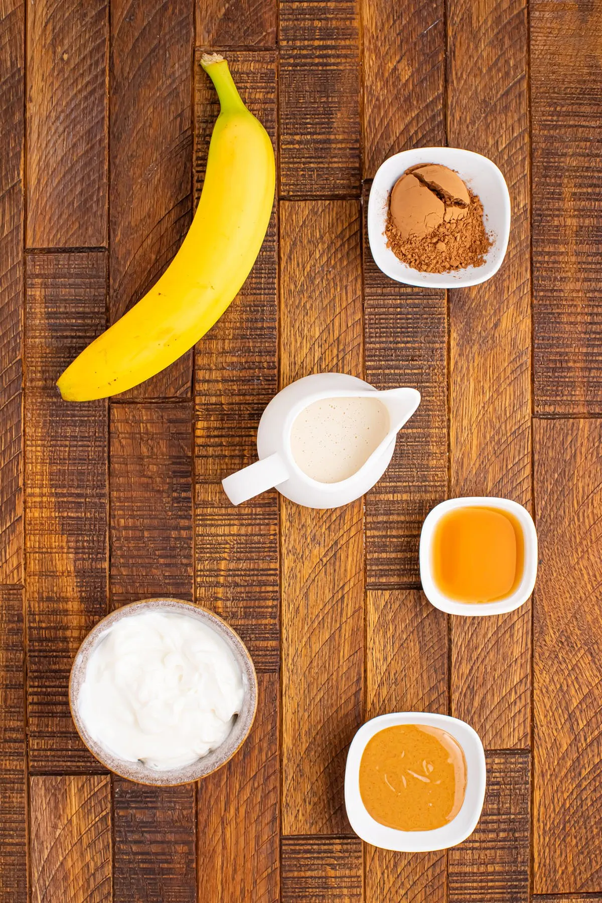 Ingredients to make a chocolate peanut butter banana smoothie.