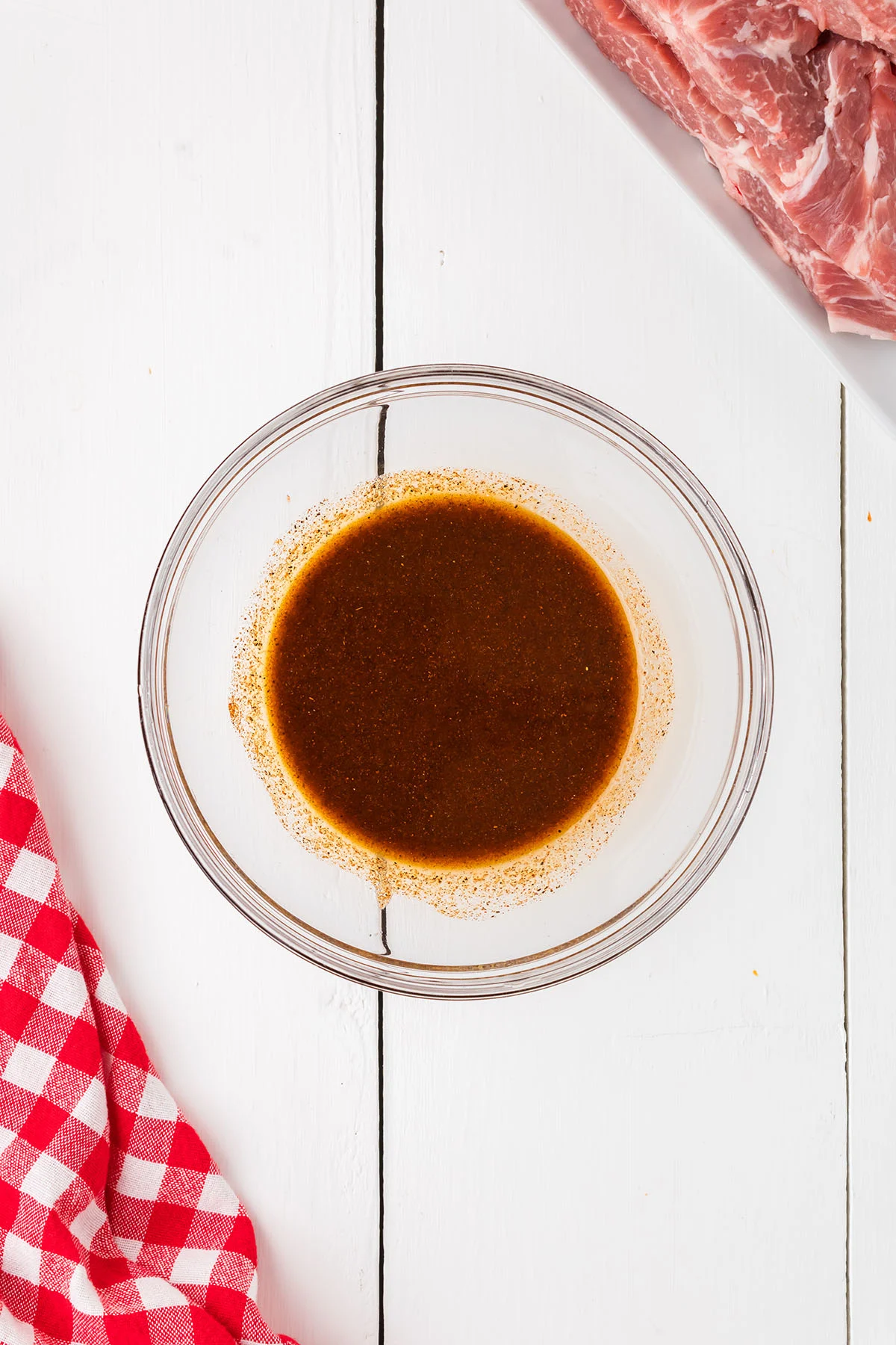 Seasoning blend for the boneless pork ribs in a glass mixing bowl.