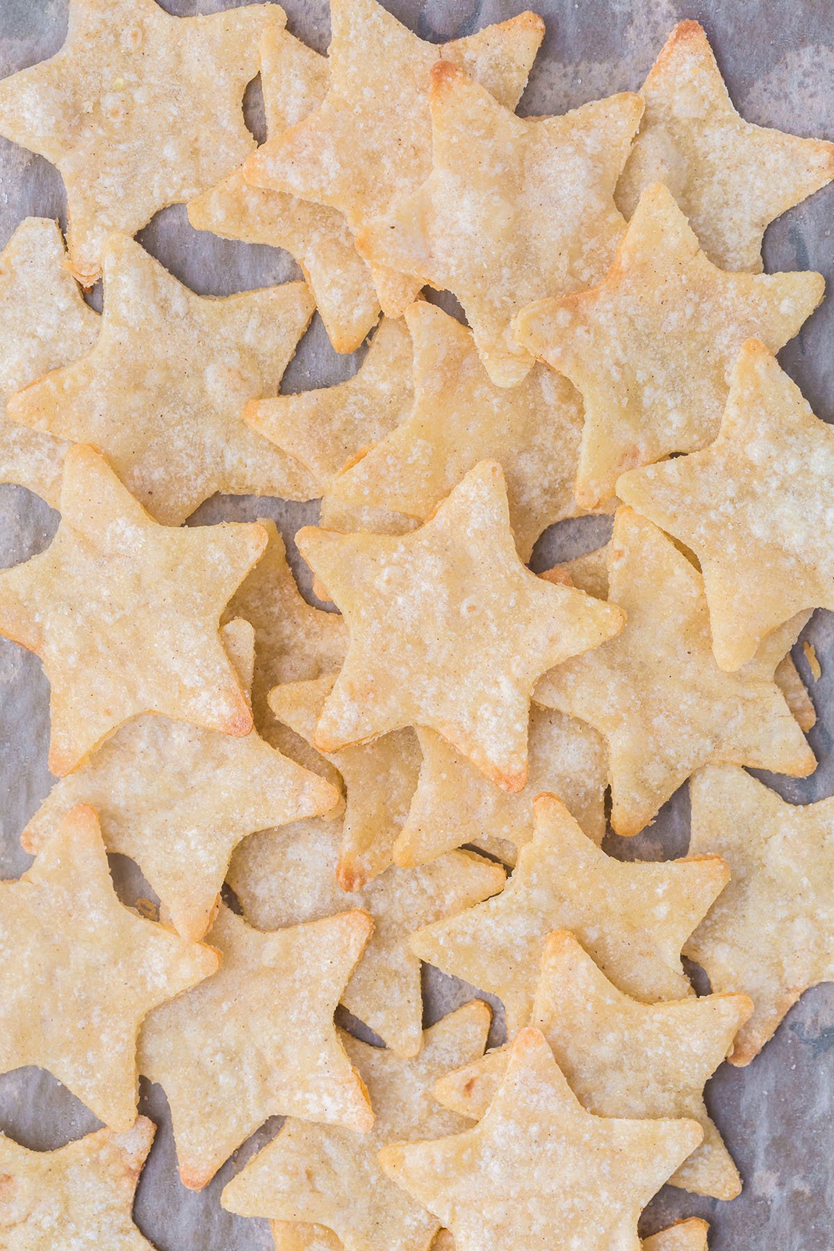 Baked star chips on parchment paper.