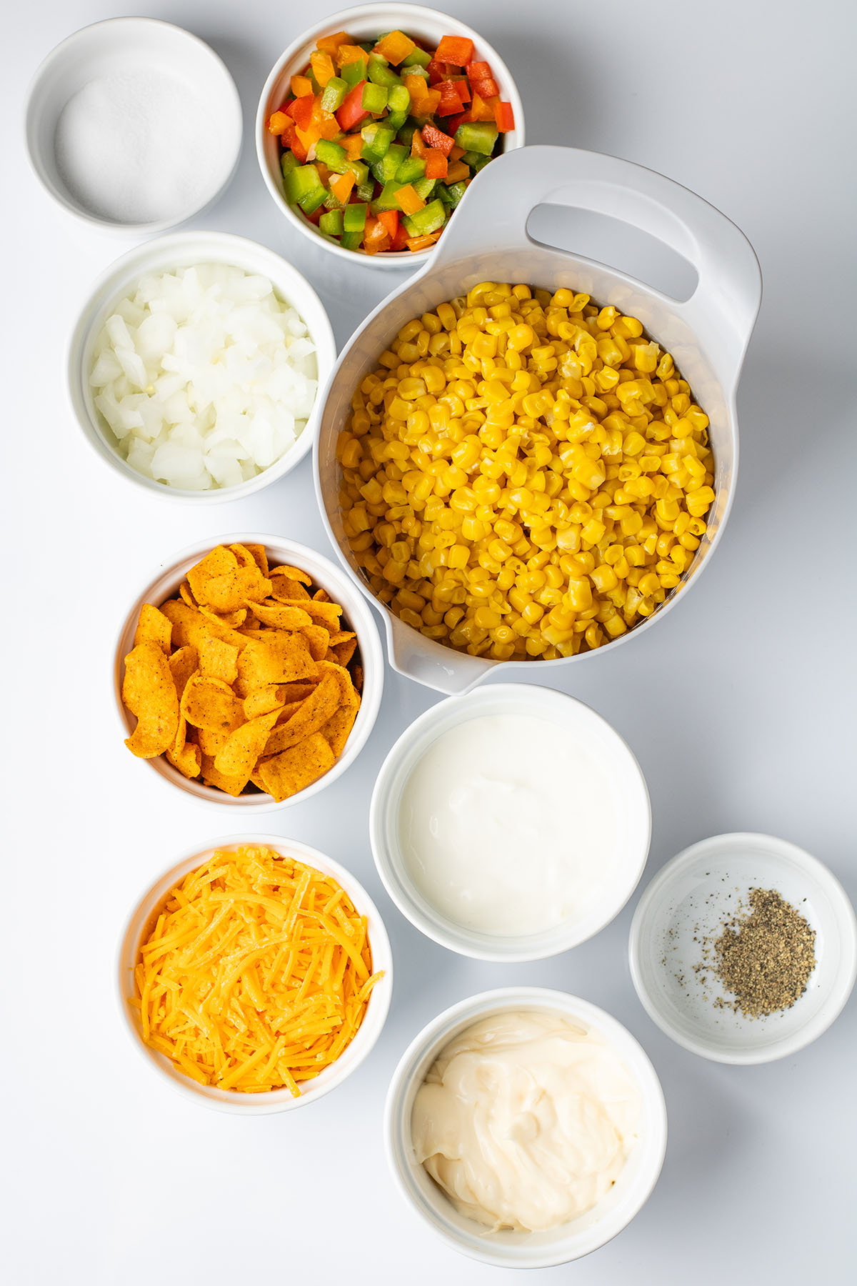 Ingredients to make Frito corn salad are set out on the counter.