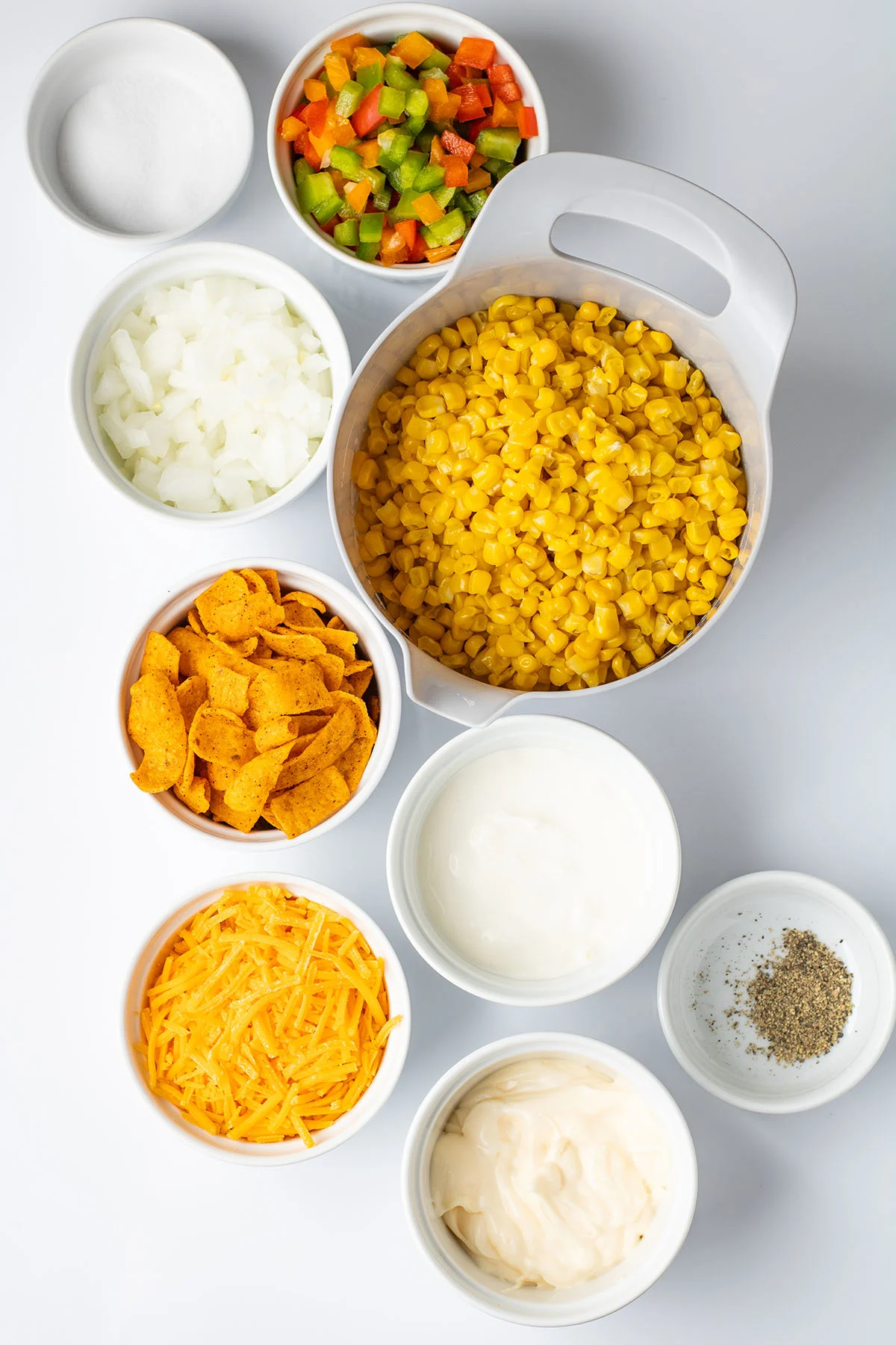 Ingredients to make Frito corn salad are set out on the counter.