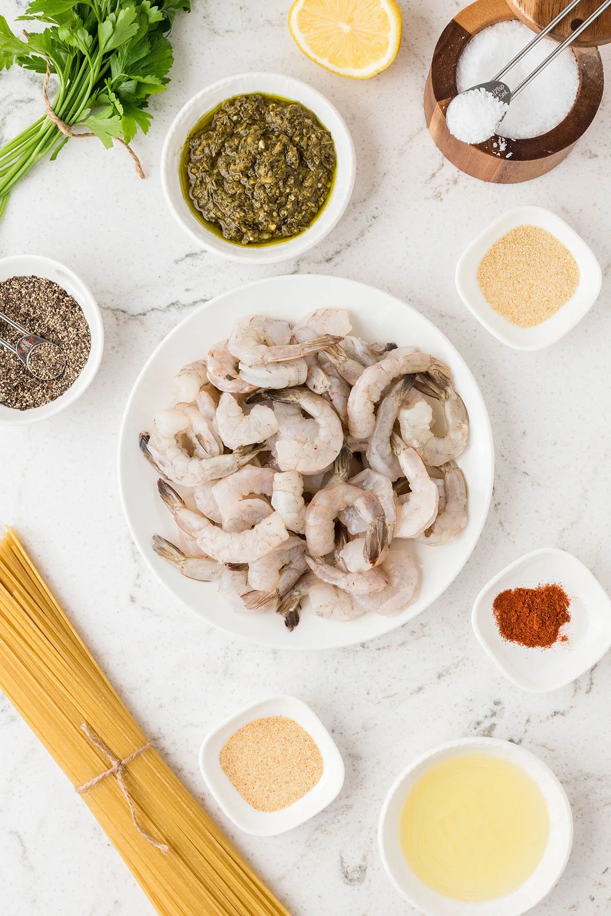 Ingredients to make Shrimp Pesto Pasta set out on the counter.