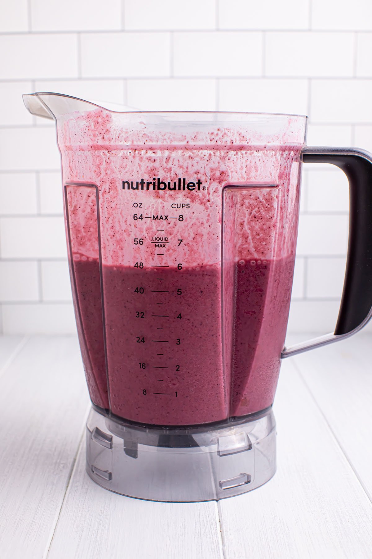 Blueberry mango smoothie is blended in a blender.