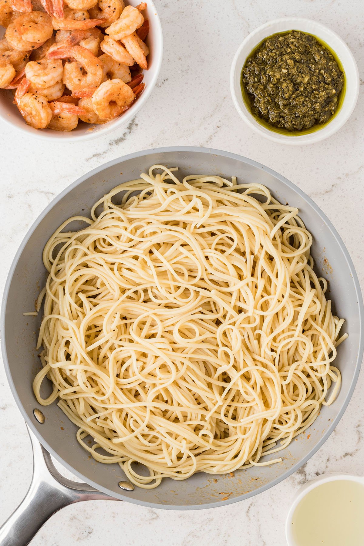 Cooked linguine in a skillet.
