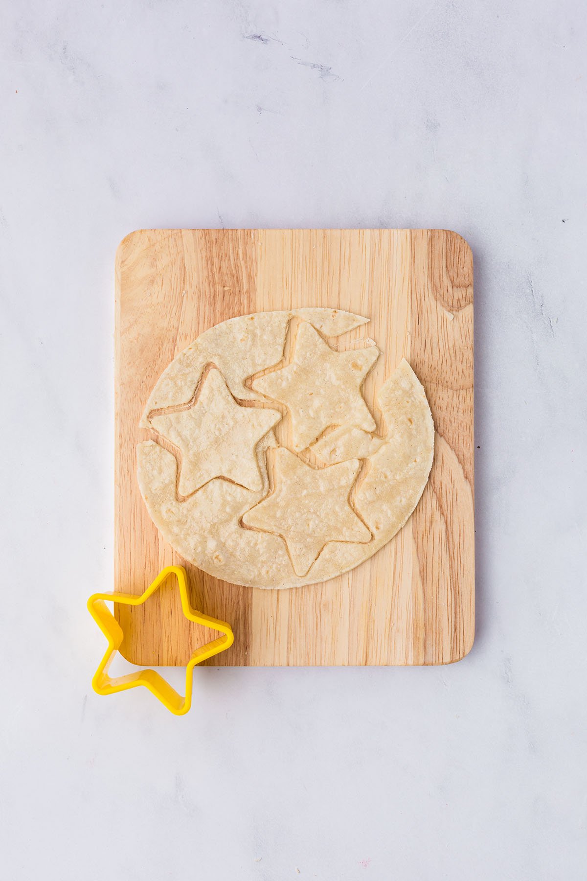Tortillas are cut with a star cookie cutter.