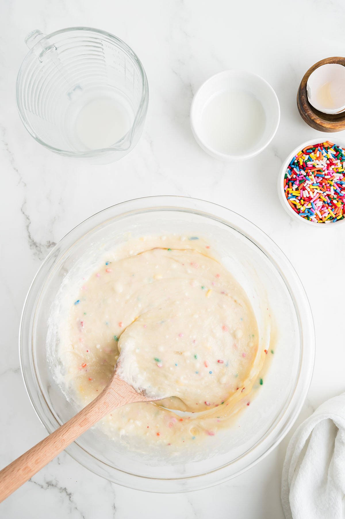 Birthday Cake Waffle batter in a glass mixing bowl.