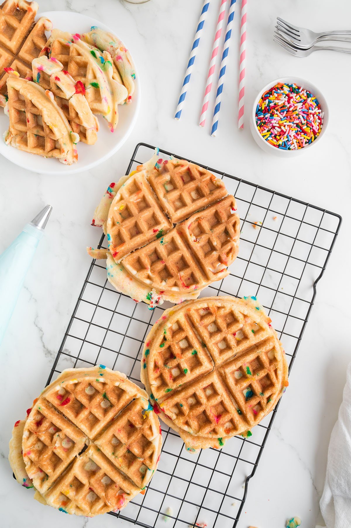 Three waffles on a wire rack.