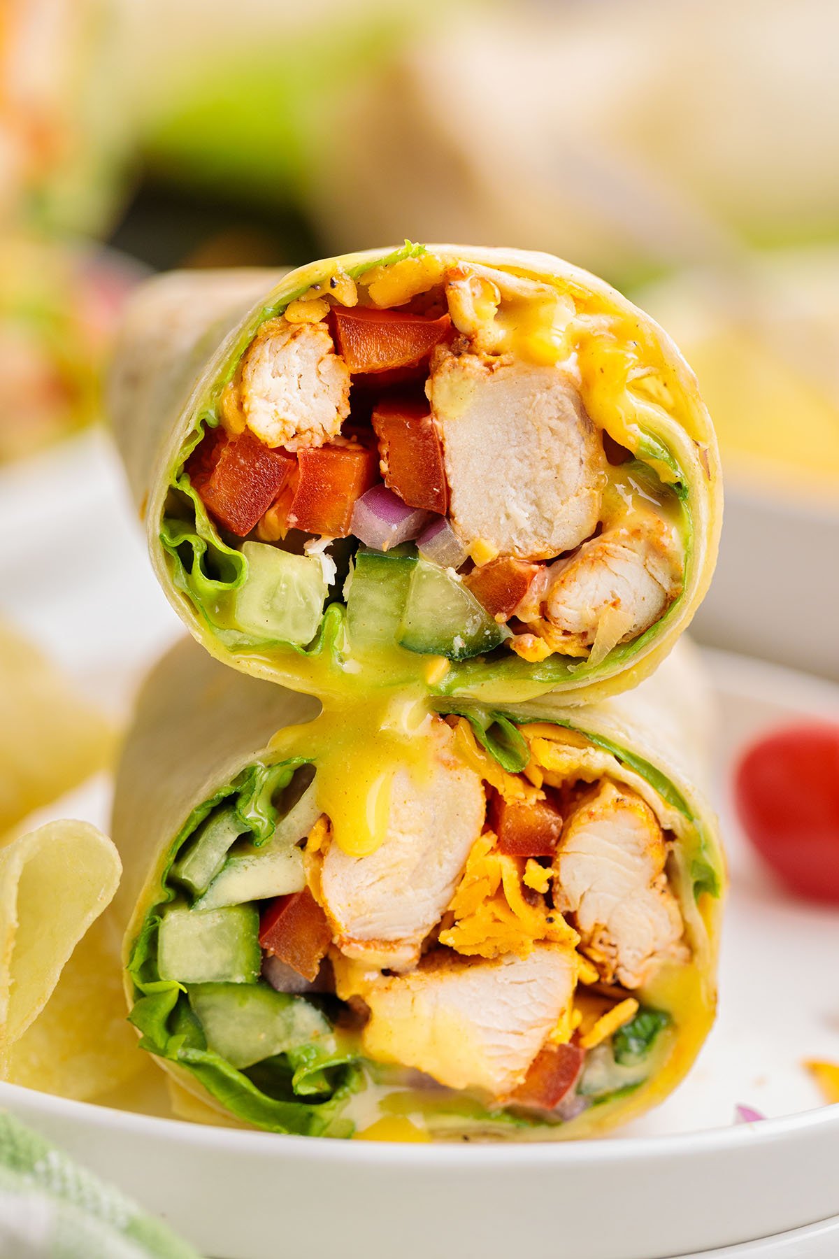 Honey Mustard Chicken Wraps stacked on a plate.
