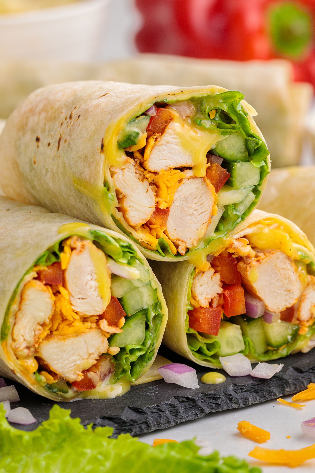 Three Honey Mustard Chicken Wraps stacked on top of each other.