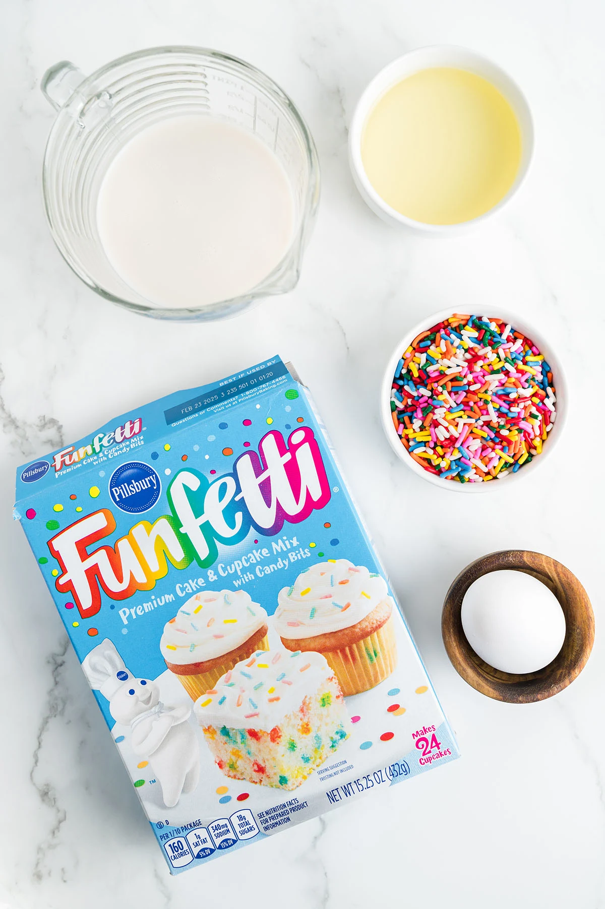 Ingredients for making Birthday Cake Waffles are set out on the counter.