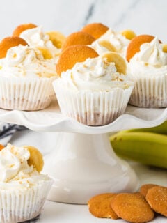 Mini Banana Cheesecakes topped with banana slices and a vanilla wafer.