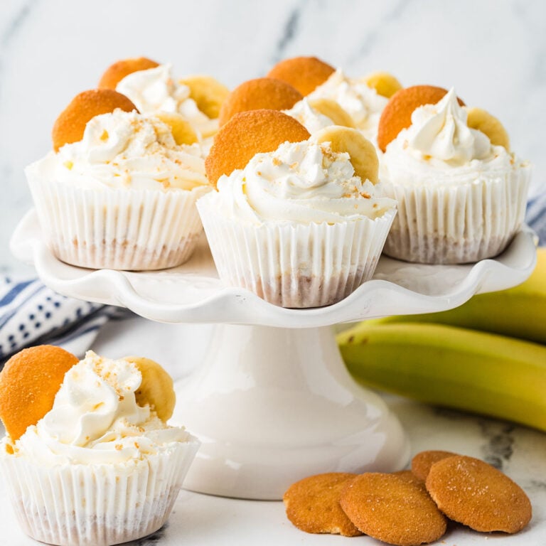 Mini Banana Cheesecakes topped with banana slices and a vanilla wafer.