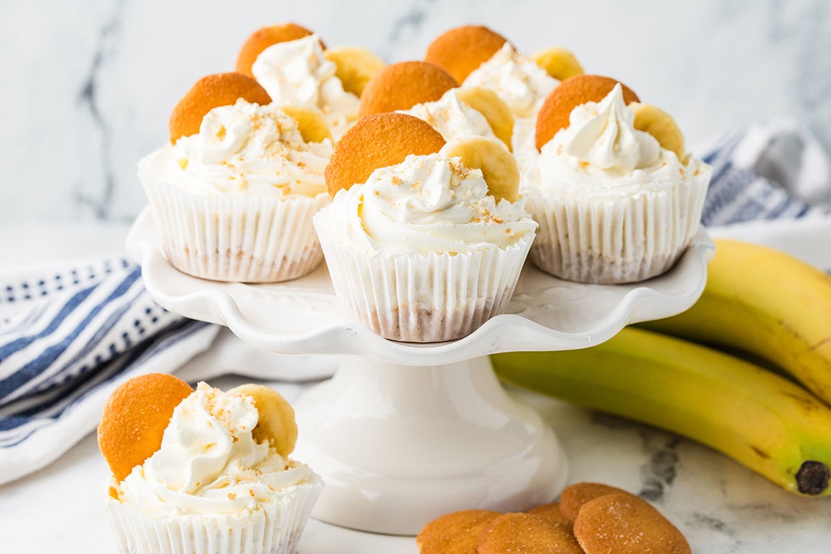 Mini Banana Cheesecakes on a cake stand.