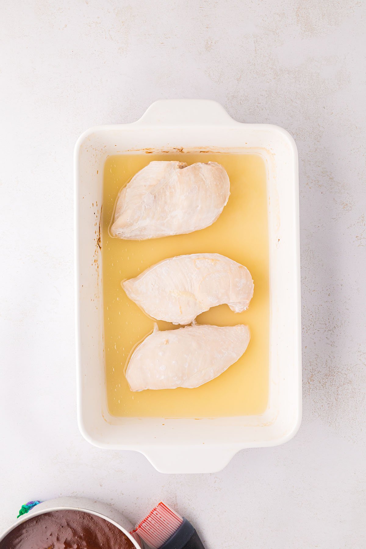 Baked chicken in pineapple juice in a baking pan.