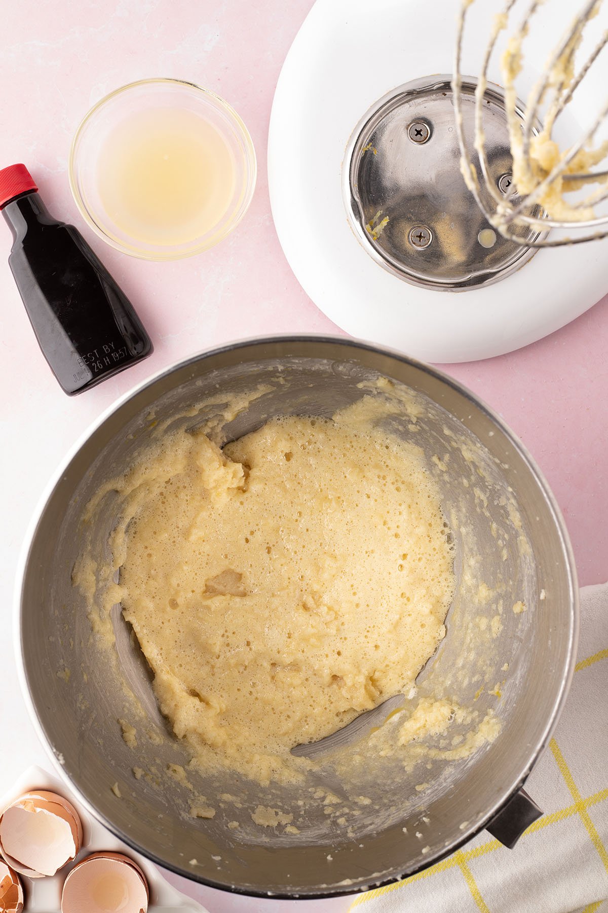 Wet ingredients of eggs, lemon juice, and vanilla added to the dry ingredients in bowl.