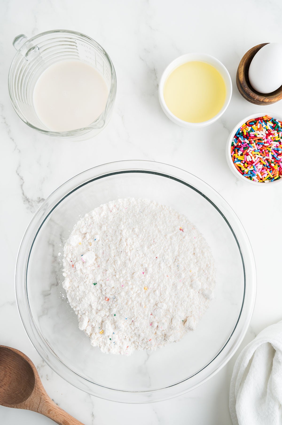 Funfetti cake mix poured in a glass mixing bowl.