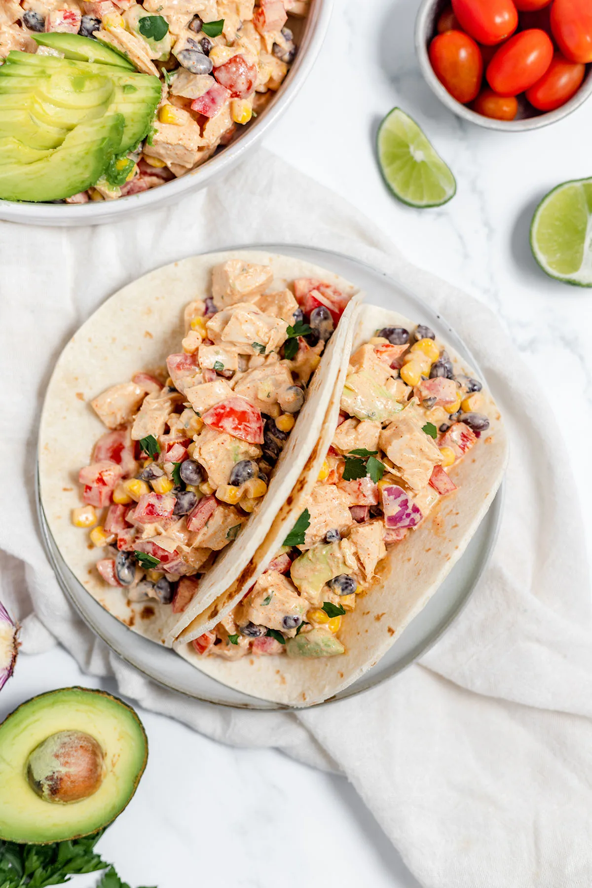 Southwest chicken salad tacos served on a white plate.