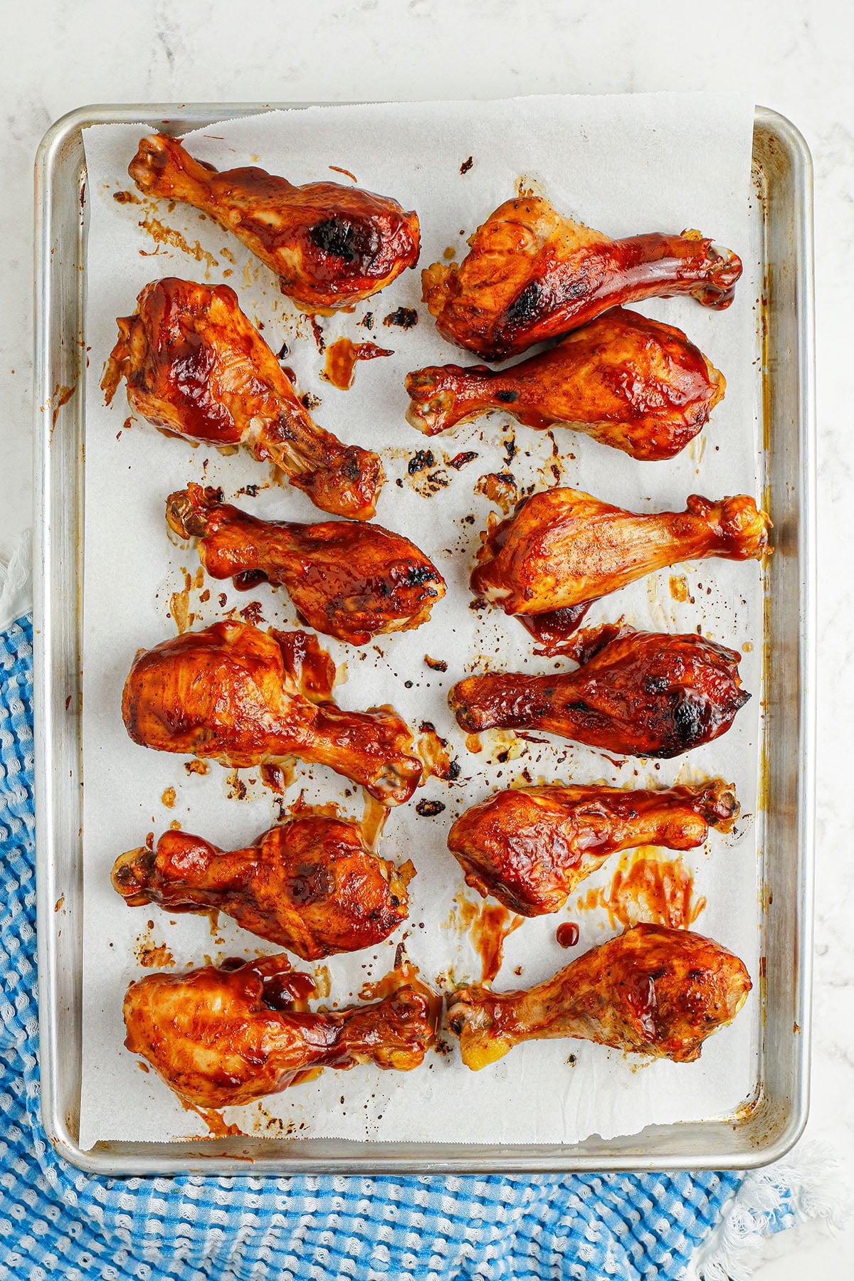 BBQ Drumsticks on a parchment paper-lined baking sheet.