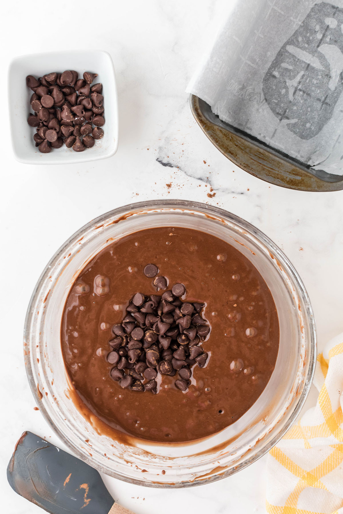 Chocolate chips are added to the cake batter in the mixing bowl.