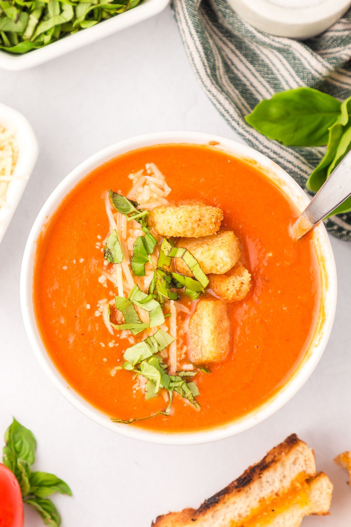 Creamy Tomato Soup topped with croutons in a white bowl.