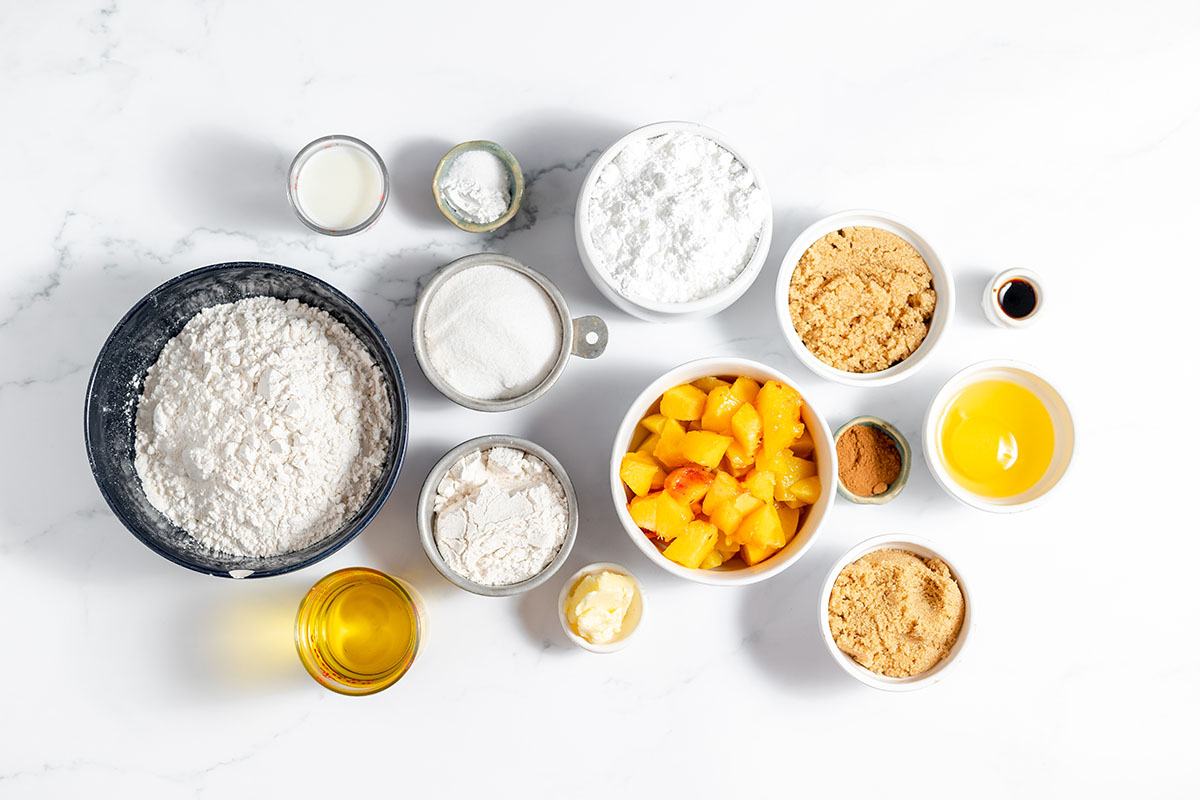 Ingredients to make peach coffee cake set out on the counter.